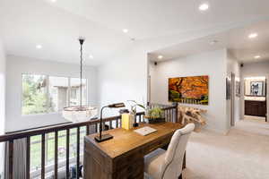 Interior space featuring recessed lighting, light carpet, vaulted ceiling, a chandelier, and baseboards