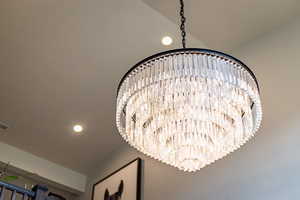 Interior details featuring recessed lighting, visible vents, and a notable chandelier