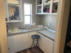 Kitchen featuring dark wood-type flooring, light countertops, and a sink