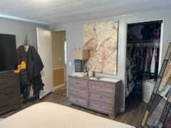 Bedroom with a closet and dark wood-style flooring