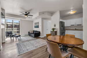 Dining space with visible vents and wood finished floors