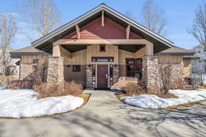 View of front of house featuring stone siding and board and batten siding