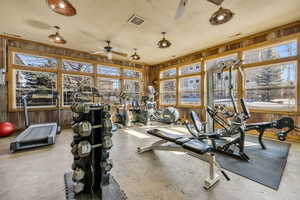 Exercise room featuring a textured ceiling, visible vents, and a ceiling fan