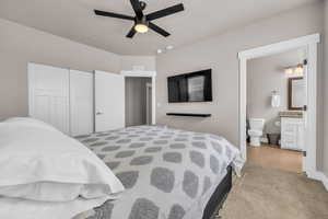 Bedroom featuring a closet, visible vents, connected bathroom, ceiling fan, and wood finished floors