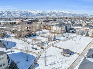 Snowy aerial view featuring a residential view and a mountain view