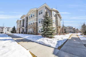 Snow covered property with a residential view