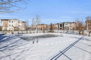 Yard covered in snow featuring a residential view and fence