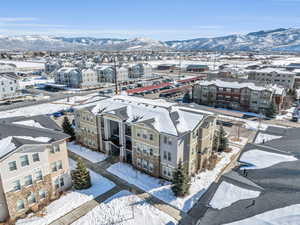 Snowy aerial view featuring a residential view and a mountain view