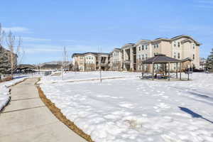 Snowy yard with a residential view and a gazebo