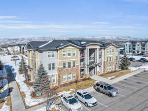 Snowy aerial view with a residential view and a mountain view