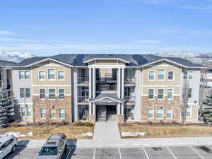 View of front of property featuring a residential view, stone siding, and a mountain view