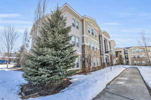 Snow covered property with a residential view