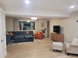 Living area featuring recessed lighting, light wood-style flooring, and baseboards