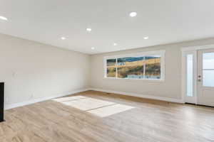 Unfurnished living room with light wood-type flooring