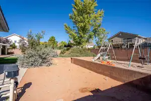 View of yard with a patio, a playground, and a fenced backyard