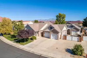 View of front of house with concrete driveway, an attached garage, a gate, fence, and a mountain view