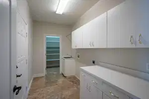 Washroom featuring hookup for a washing machine, cabinet space, hookup for an electric dryer, a sink, and a textured ceiling