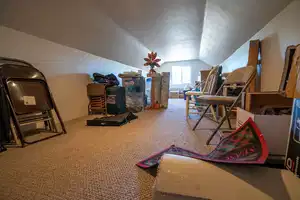 Interior space with lofted ceiling, carpet floors, a textured ceiling, and a textured wall