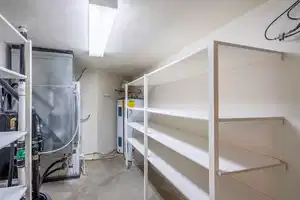 Storage area featuring electric water heater