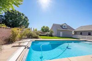 View of swimming pool featuring a fenced in pool, a fenced backyard, and a yard