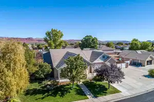 View of front facade with a front yard, driveway, a residential view, and a mountain view