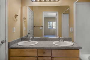 Bathroom featuring double vanity and a sink