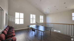 Game room with high vaulted ceiling, recessed lighting, baseboards, and wood finished floors