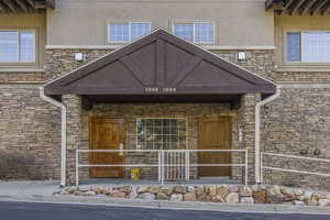 View of exterior entry with stucco siding