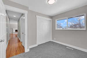 Unfurnished bedroom featuring a closet, visible vents, a fireplace, and baseboards