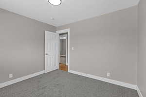 Carpeted spare room with baseboards