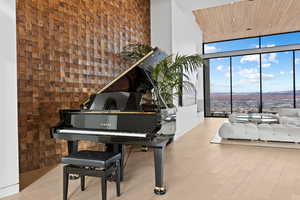 Sitting room with recessed lighting, a high ceiling, wood finished floors, wood ceiling, and expansive windows