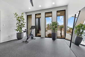 Exercise area featuring a ceiling fan, recessed lighting, and visible vents