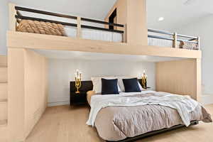 Bedroom with recessed lighting and wood finished floors