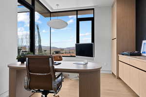 Home office with light wood-type flooring