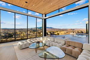 Sunroom featuring wooden ceiling and a mountain view