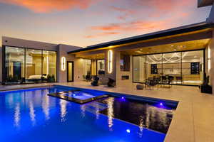 View of pool with a pool with connected hot tub and a patio area