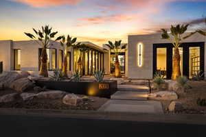 Pueblo revival-style home featuring stucco siding