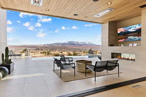 View of patio with a large fireplace and visible vents