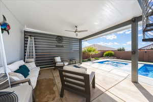 View of patio / terrace with a fenced in pool, an outdoor fire pit, a fenced backyard, and ceiling fan