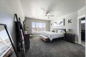 Carpeted bedroom featuring baseboards, visible vents, and ceiling fan