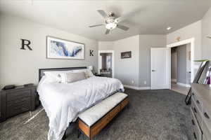 Bedroom with carpet floors, ceiling fan, and baseboards