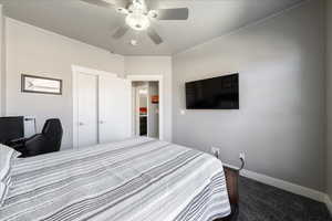 Bedroom featuring carpet floors, baseboards, and a ceiling fan