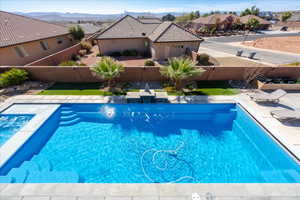 View of pool featuring a fenced backyard, a residential view, a fenced in pool, and a patio