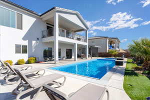 Exterior space with a patio area and a fenced in pool