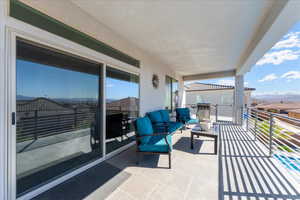 Balcony featuring a mountain view and a sunroom