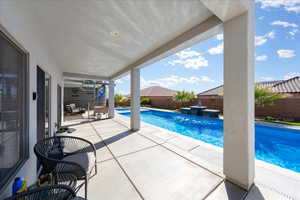 View of swimming pool featuring a fenced backyard, a fenced in pool, and a patio