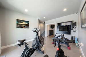 Workout area with baseboards and recessed lighting