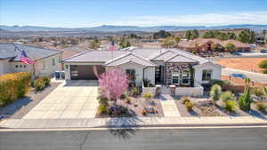 View of front of house featuring driveway, a tile roof, fence, a mountain view, and stucco siding