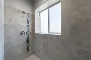 Bathroom featuring a tile shower