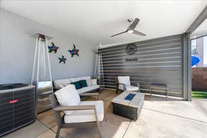 View of patio / terrace with central AC, an outdoor living space with a fire pit, and a ceiling fan